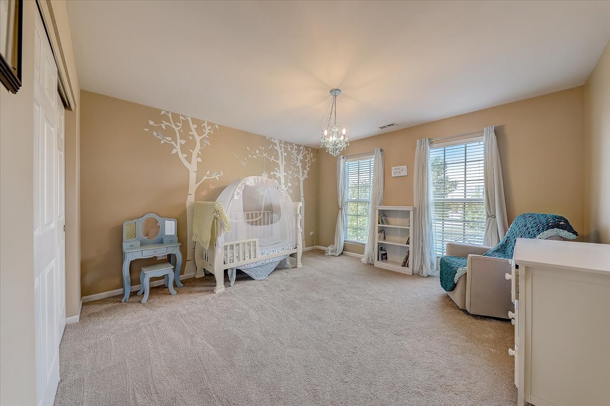 406 Aviary Lane Bolingbrook, IL 60490 - Photo 32 of 46 a living room with furniture and a chandelier