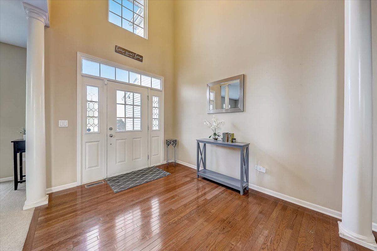406 Aviary Lane Bolingbrook, IL 60490 - Photo 5 of 46 a view of an empty room with window and wooden floor