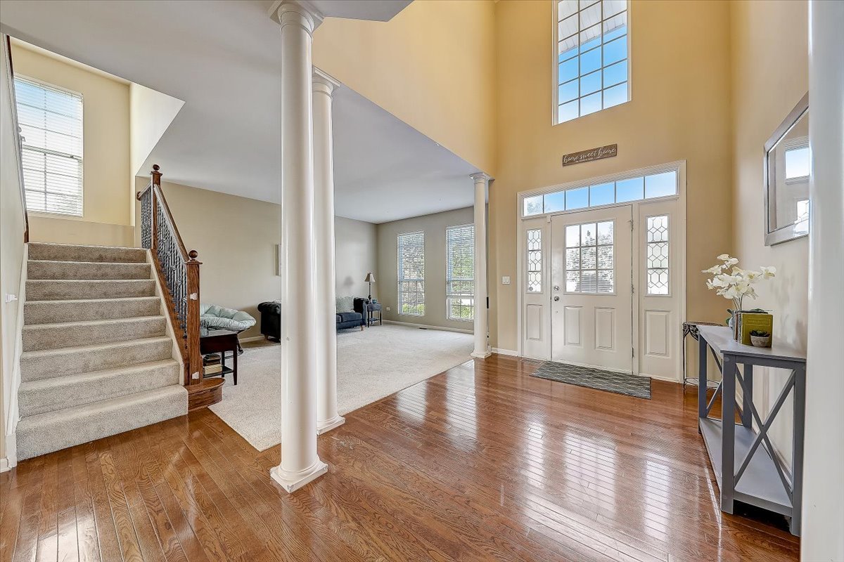 406 Aviary Lane Bolingbrook, IL 60490 - Photo 6 of 46 a view of an entryway with wooden floor and a livingroom