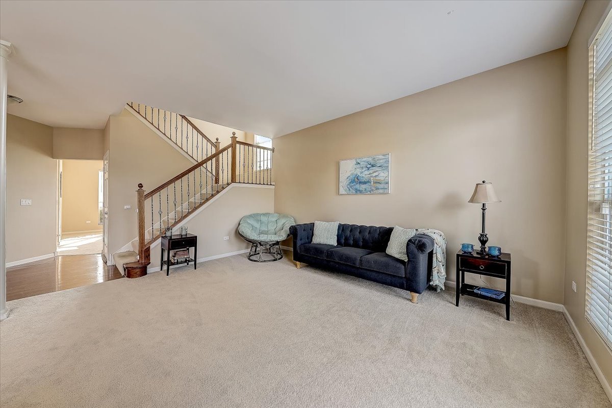 406 Aviary Lane Bolingbrook, IL 60490 - Photo 8 of 46 a living room with furniture and a lamp with kitchen view