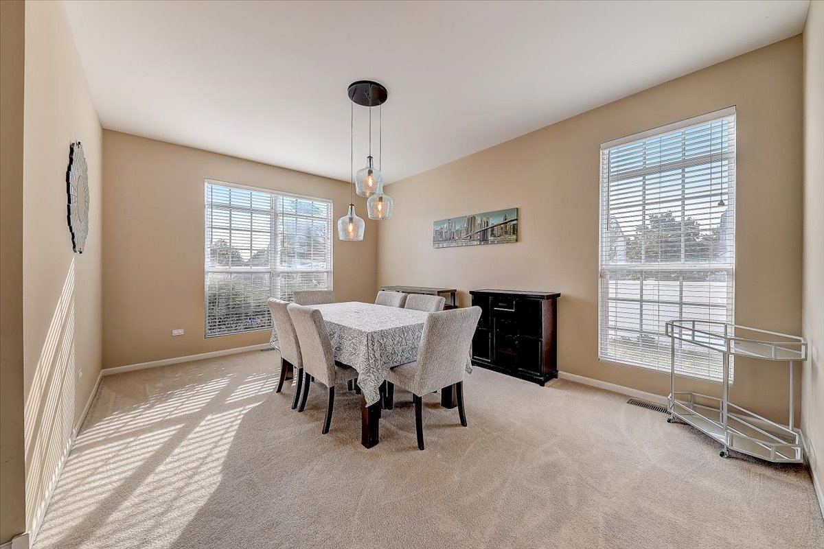 406 Aviary Lane Bolingbrook, IL 60490 - Photo 9 of 46 a dining room with furniture and windows