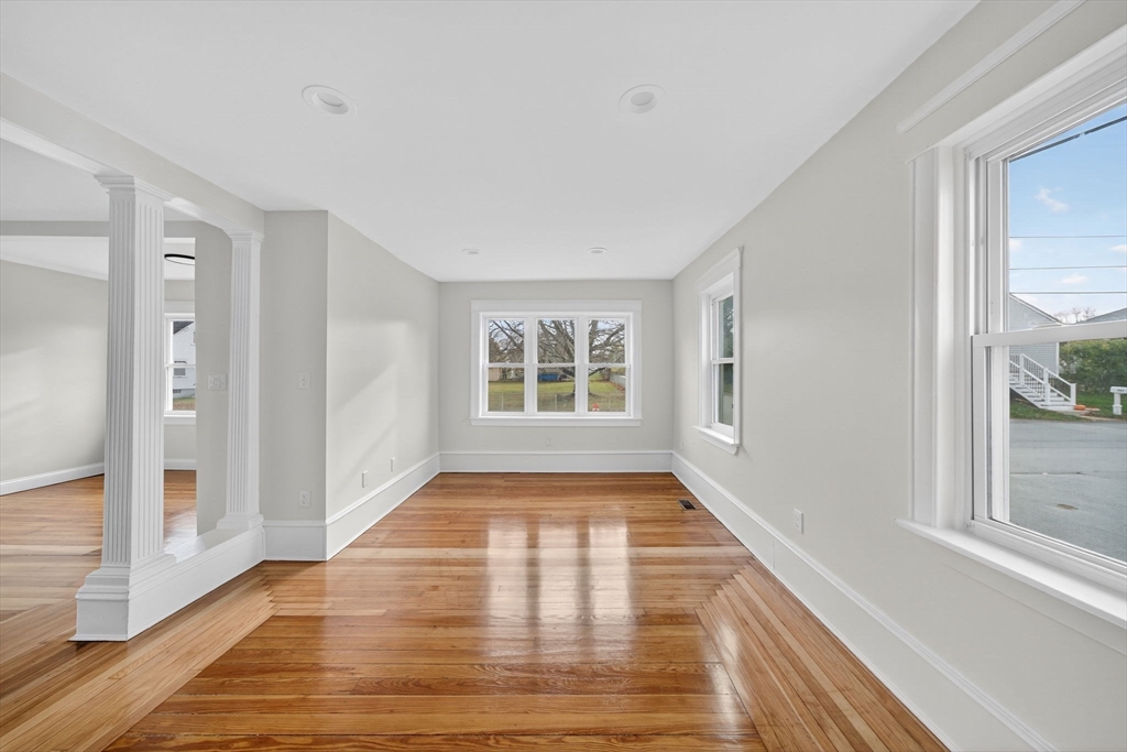 228 Dickinson Street Fall River, MA 02721 - Photo 11 of 40 a view of an empty room with wooden floor and a window