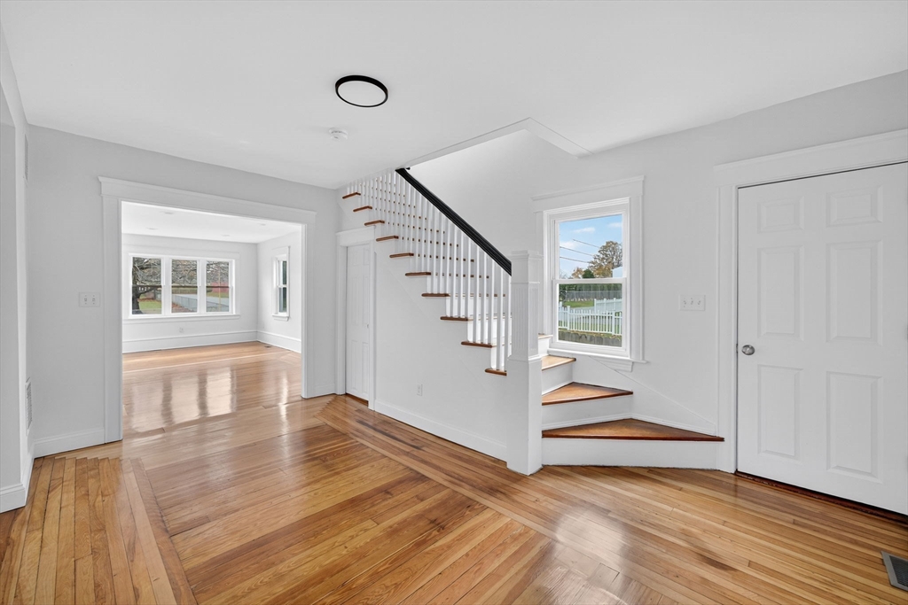 228 Dickinson Street Fall River, MA 02721 - Photo 14 of 40 a view of an entryway with wooden floor and stairs
