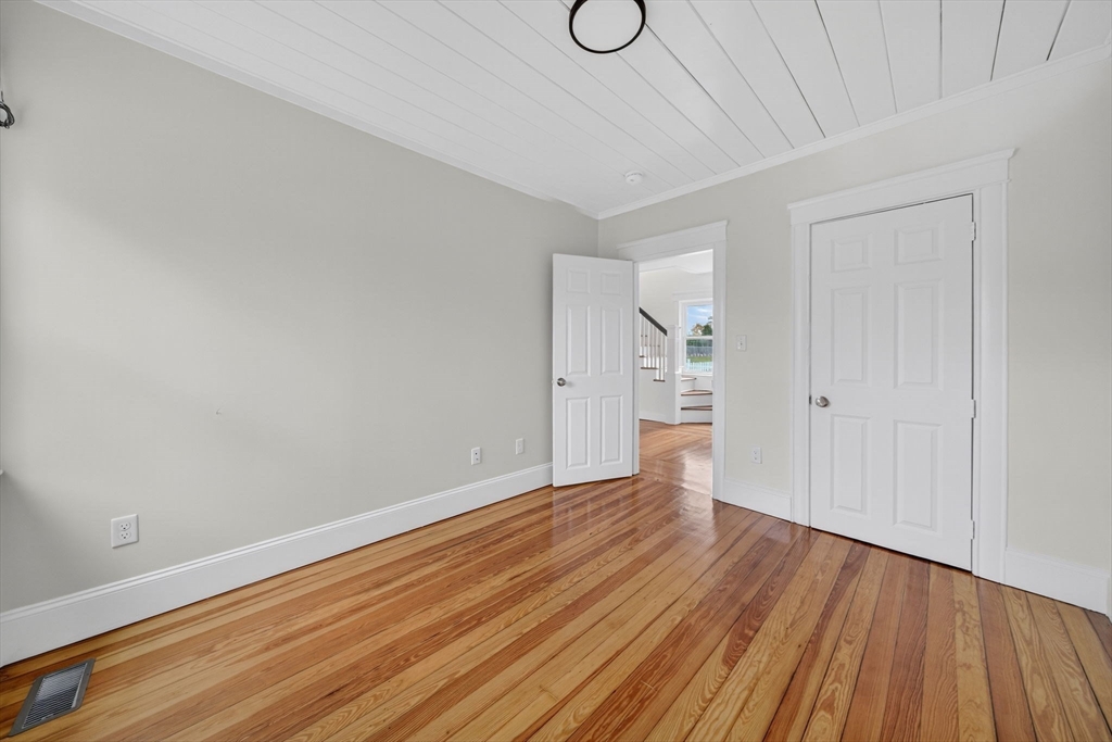 228 Dickinson Street Fall River, MA 02721 - Photo 16 of 40 a view of an empty room with wooden floor and a window
