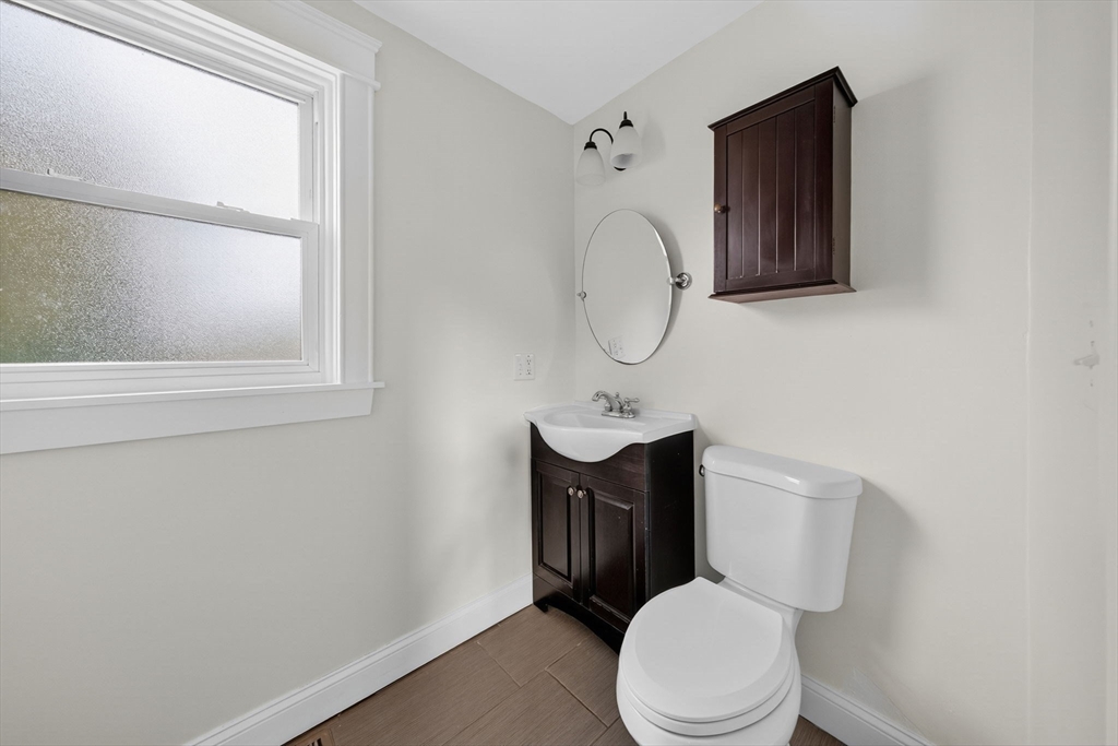 228 Dickinson Street Fall River, MA 02721 - Photo 17 of 40 a white toilet sitting next to a bathroom sink