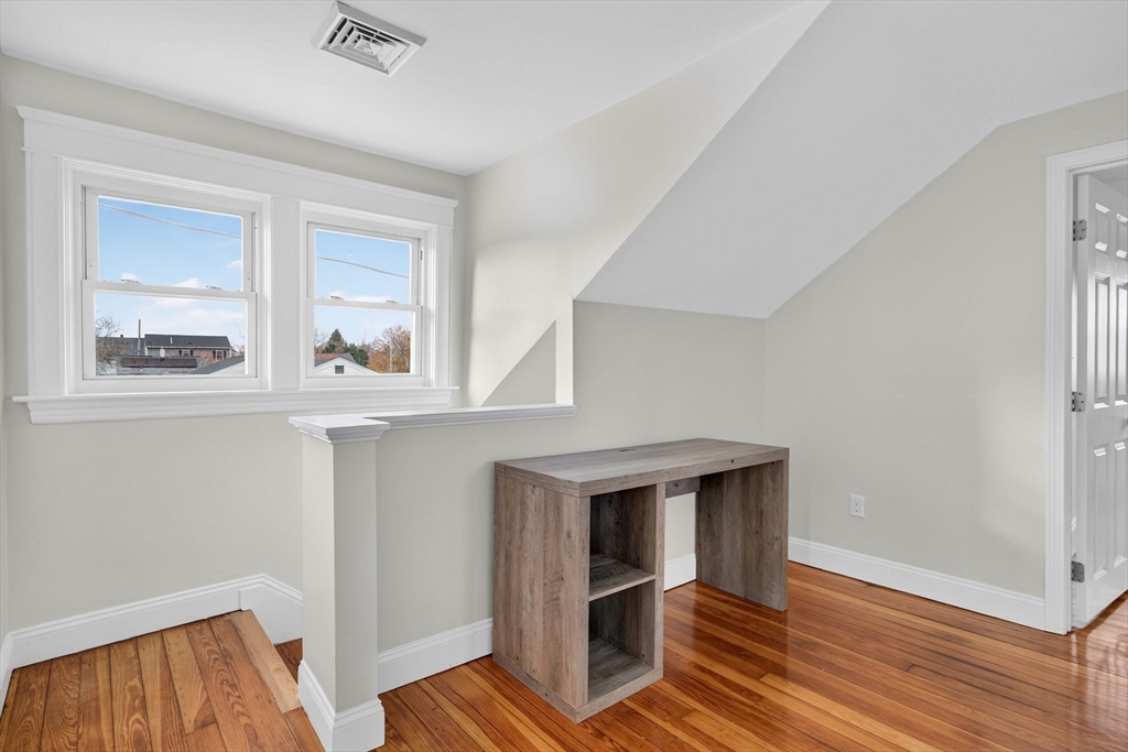 228 Dickinson Street Fall River, MA 02721 - Photo 20 of 40 a view of an empty room with wooden floor and a window