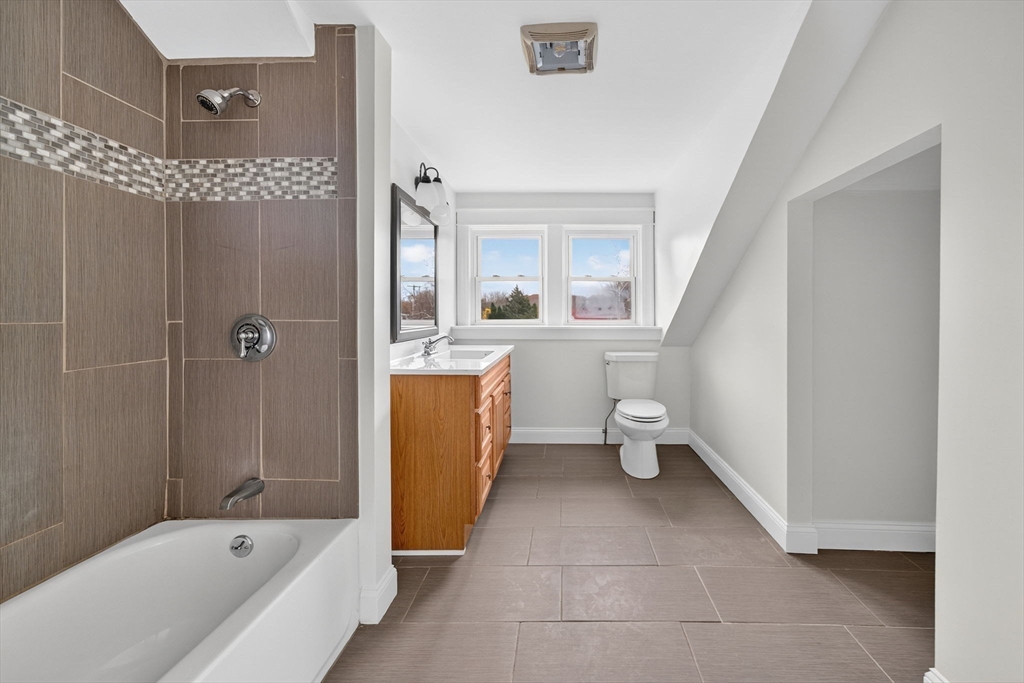 228 Dickinson Street Fall River, MA 02721 - Photo 21 of 40 a bathroom with a bath tub a toilet and a shower