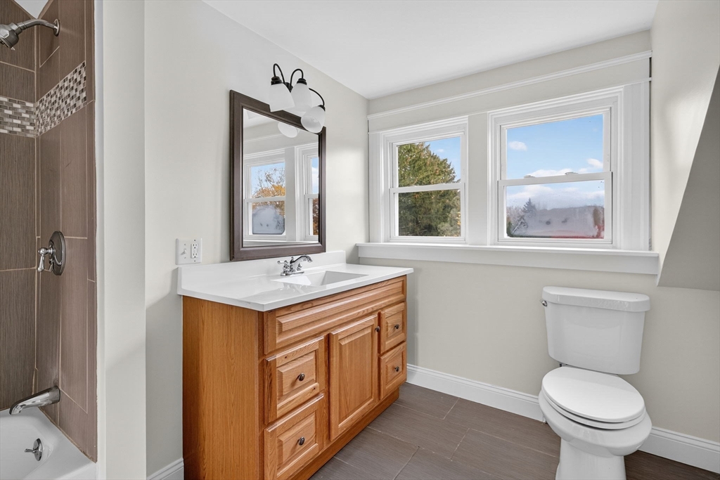 228 Dickinson Street Fall River, MA 02721 - Photo 22 of 40 a bathroom with a toilet sink and mirror