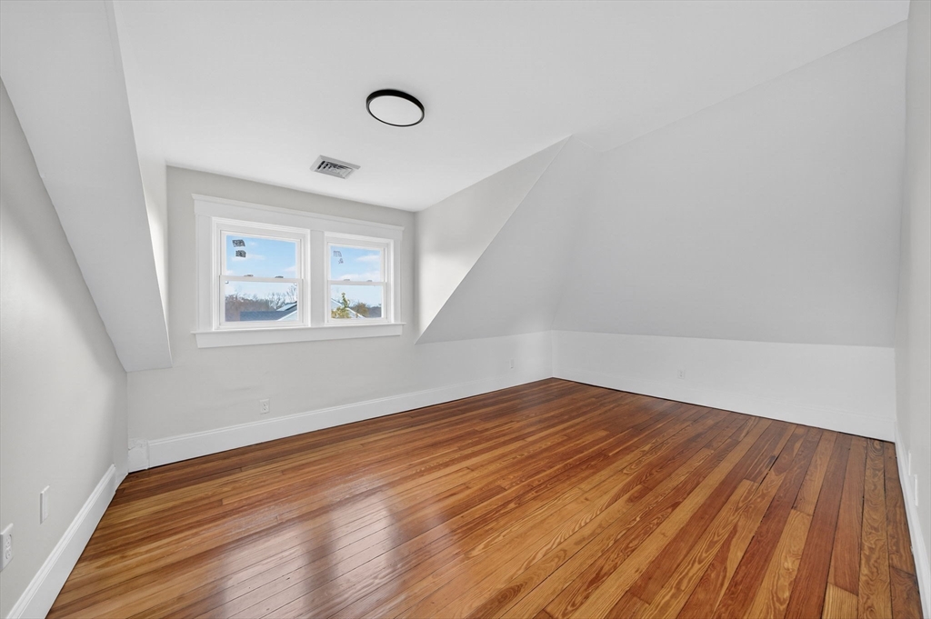 228 Dickinson Street Fall River, MA 02721 - Photo 23 of 40 a view of empty room with wooden floor and fan
