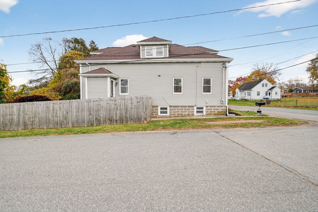 228 Dickinson Street Fall River, MA 02721 - Photo 28 of 40 a view of a house with a yard and a large tree