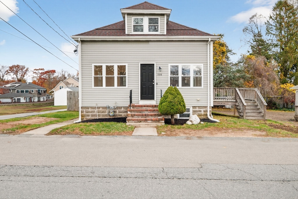 228 Dickinson Street Fall River, MA 02721 - Photo 3 of 40 a front view of a house with a yard and potted plants