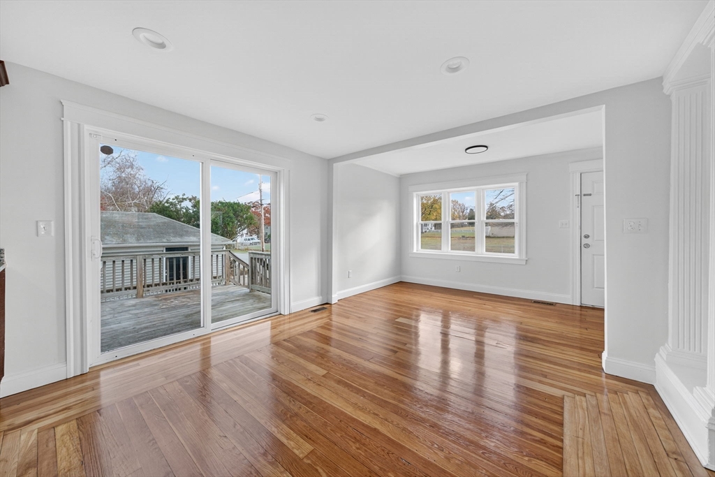228 Dickinson Street Fall River, MA 02721 - Photo 9 of 40 a view of an empty room with wooden floor and a window