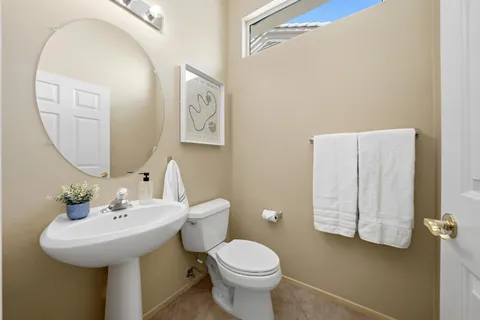 a bathroom with a toilet sink and mirror