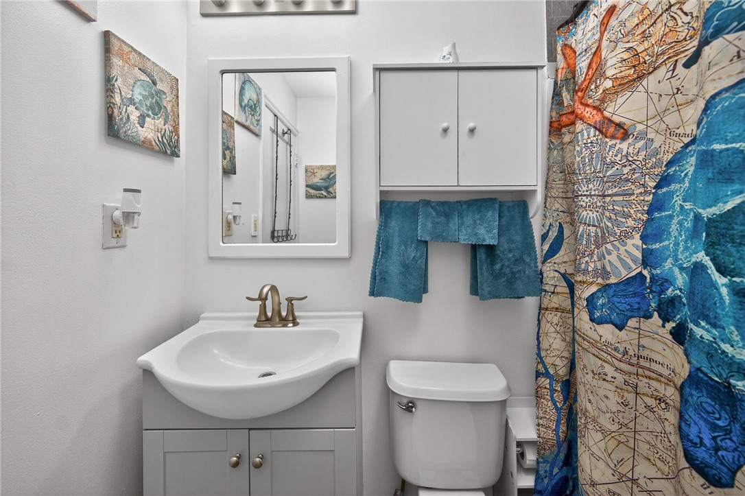 3301 Wildwood Road Middletown, OH 45042 - Photo 23 of 68 This bright bathroom features a vanity, mirror, and a shower with a unique map-themed curtain.
