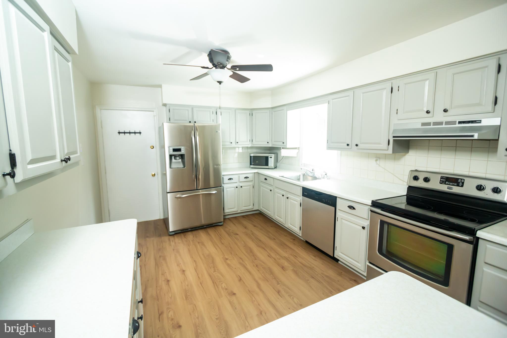 11623 Rivershore Drive Dunkirk, MD 20754 - Photo 13 of 49 a kitchen with stainless steel appliances a sink cabinets and wooden floor