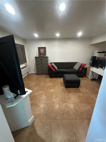 a living room with furniture and next to a window