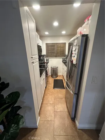 a kitchen with a stove and a refrigerator