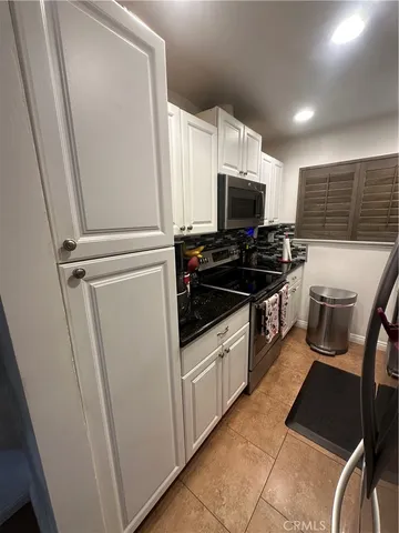 a kitchen with granite countertop a sink and a stove top oven