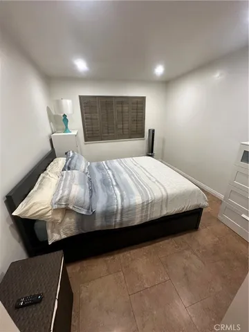 a living room with furniture a flat screen tv and kitchen view