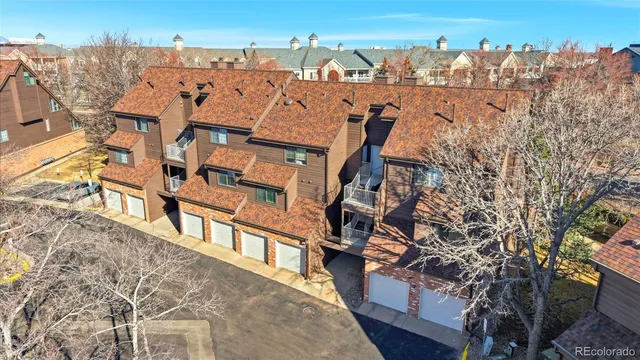 an aerial view of a house with a yard and mountain view in back