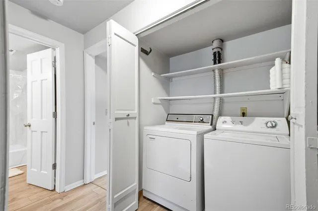 a view of washer and dryer with wooden floor