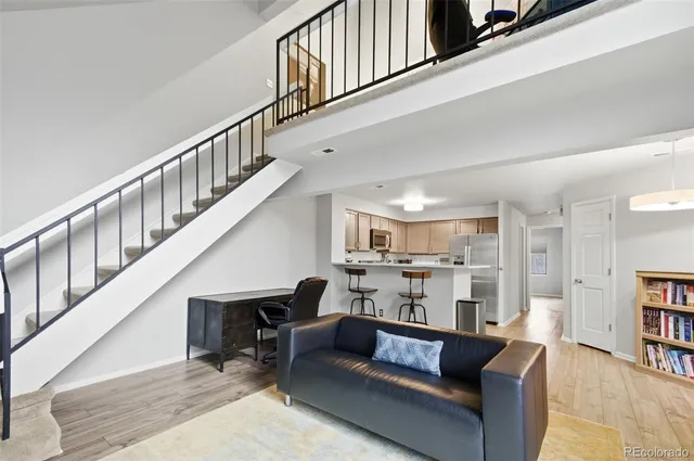 a living room with furniture and kitchen view