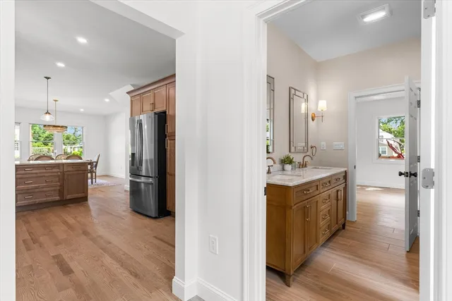a kitchen with a refrigerator a sink and a stove top oven