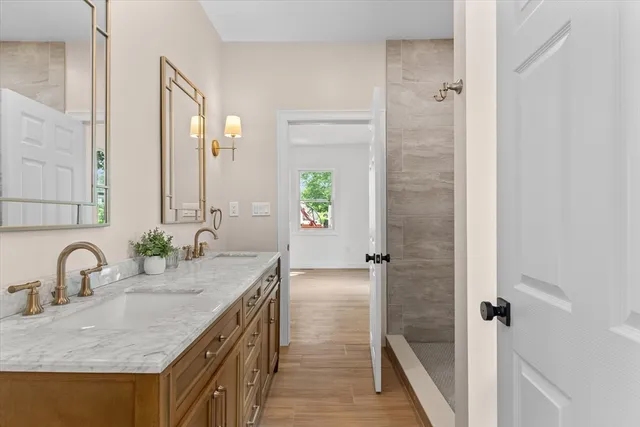 a bathroom with a granite countertop sink and a mirror