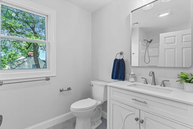 a bathroom with a sink a toilet and a mirror