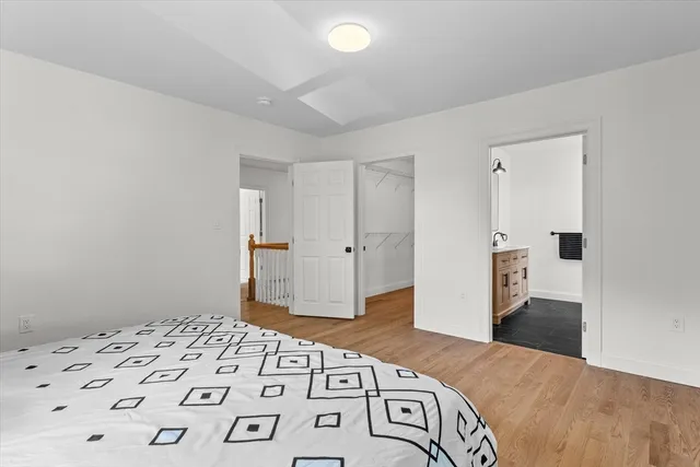 a bedroom with a bed and a view of kitchen