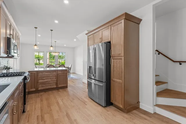 a kitchen with stainless steel appliances a refrigerator sink and stove