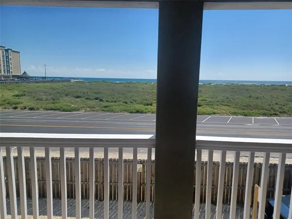 a view of a balcony with an ocean