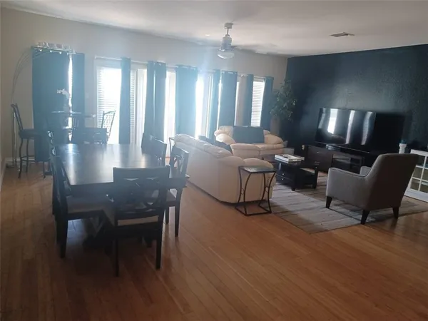 a living room with furniture and a lamp