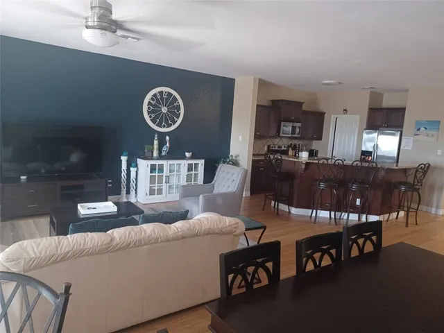 a living room with furniture a clock and a clock