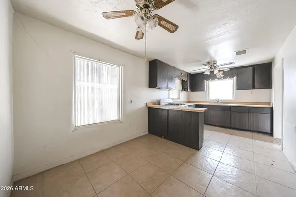 a large kitchen with a cabinets and chandelier