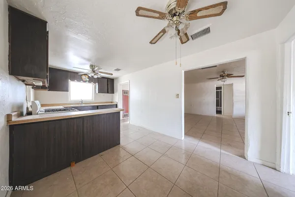 a kitchen with kitchen island granite countertop a sink a counter top space appliances and cabinets