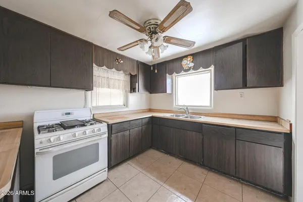 a kitchen with stainless steel appliances a stove a sink and cabinets