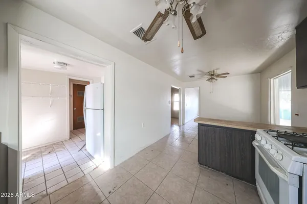 a view of a kitchen with a sink and cabinet chandelier fan