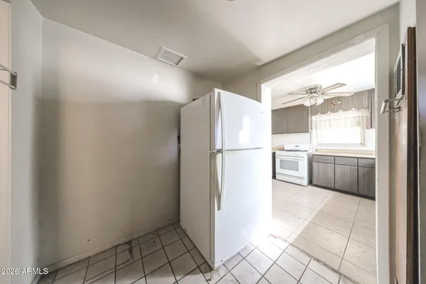 a kitchen with a refrigerator a washer and dryer