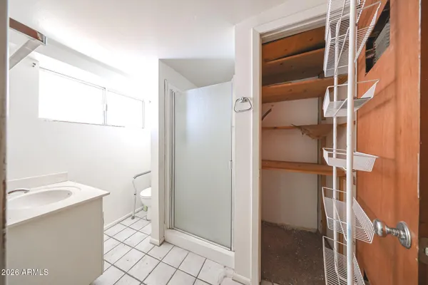 a bathroom with a granite countertop toilet and a sink