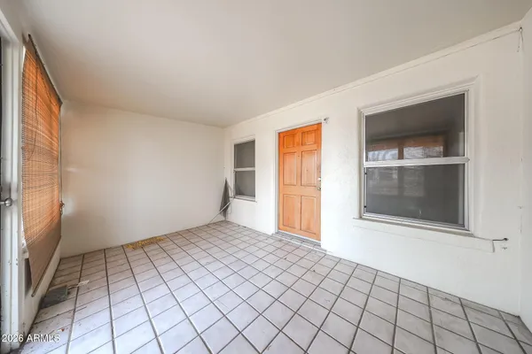 an empty room with windows and closet