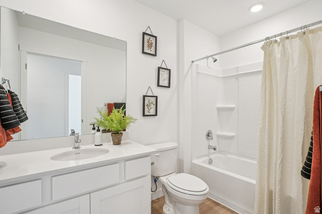 2097 North Ostler Peak Road, Unit 115 Heber City, UT 84032 - Photo 11 of 33 Bathroom featuring a white vanity with an integrated sink, polished chrome faucet, and a large wall-mounted mirror