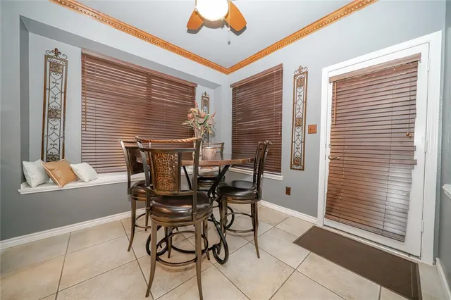 a dining room with furniture and window