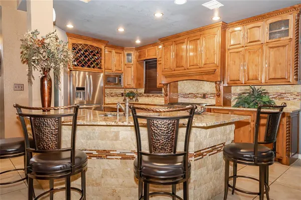 a kitchen with stainless steel appliances granite countertop a refrigerator and cabinets