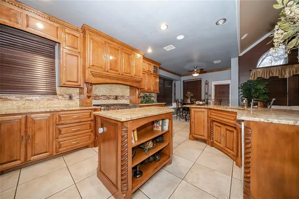 a kitchen with stainless steel appliances granite countertop a stove and cabinets