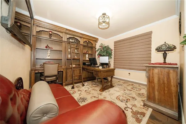 a living room with furniture a rug and a window