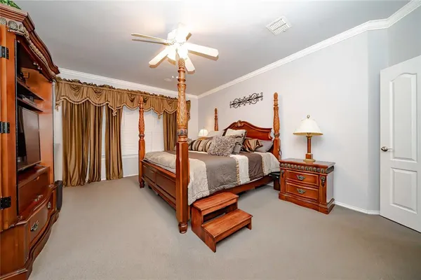 a bedroom with a bed and a chandelier