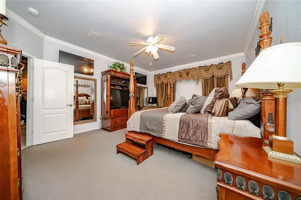 a bedroom with a bed and a chandelier