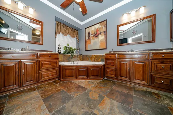 a spacious bathroom with a double vanity sink and a mirror