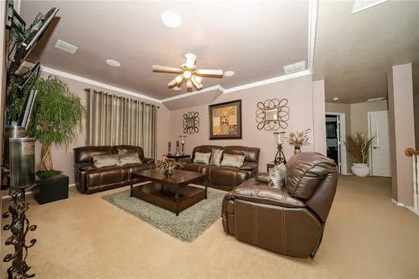 a living room with furniture ceiling fan and a rug